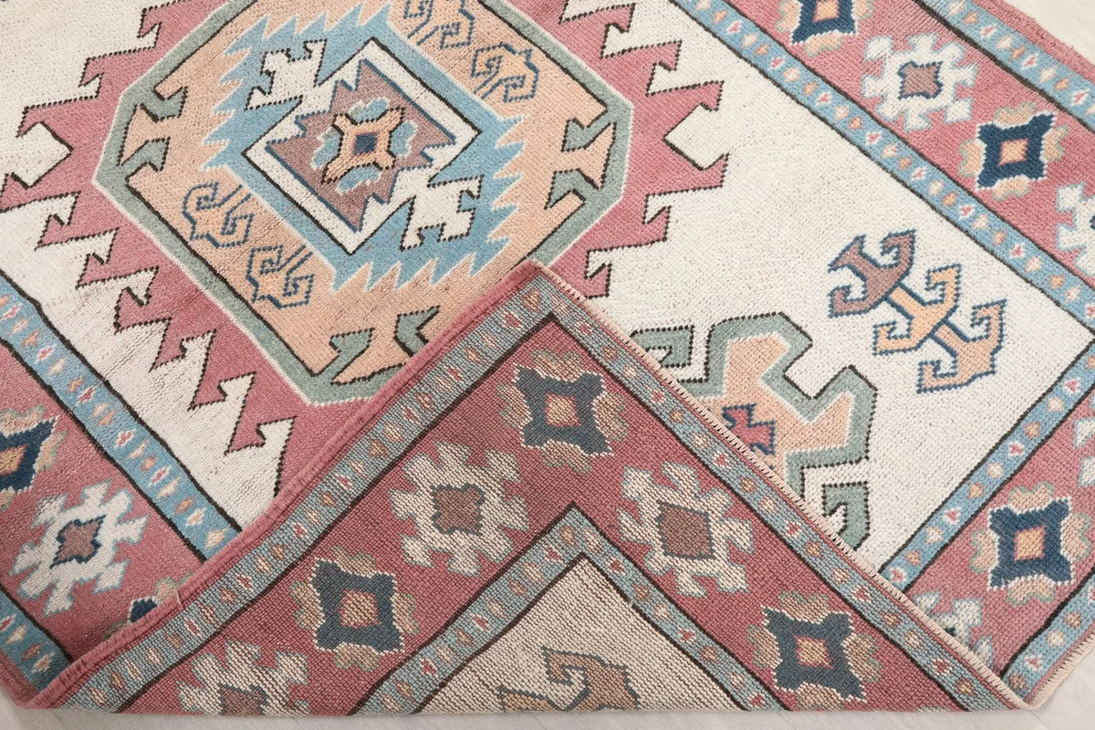 Folded corner of the rug revealing the textile's thickness and reverse side