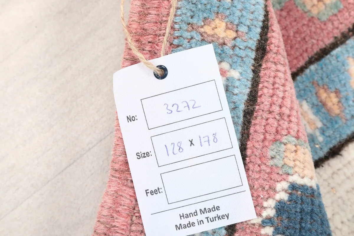 Product tag attached to the rug, showing size and origin details