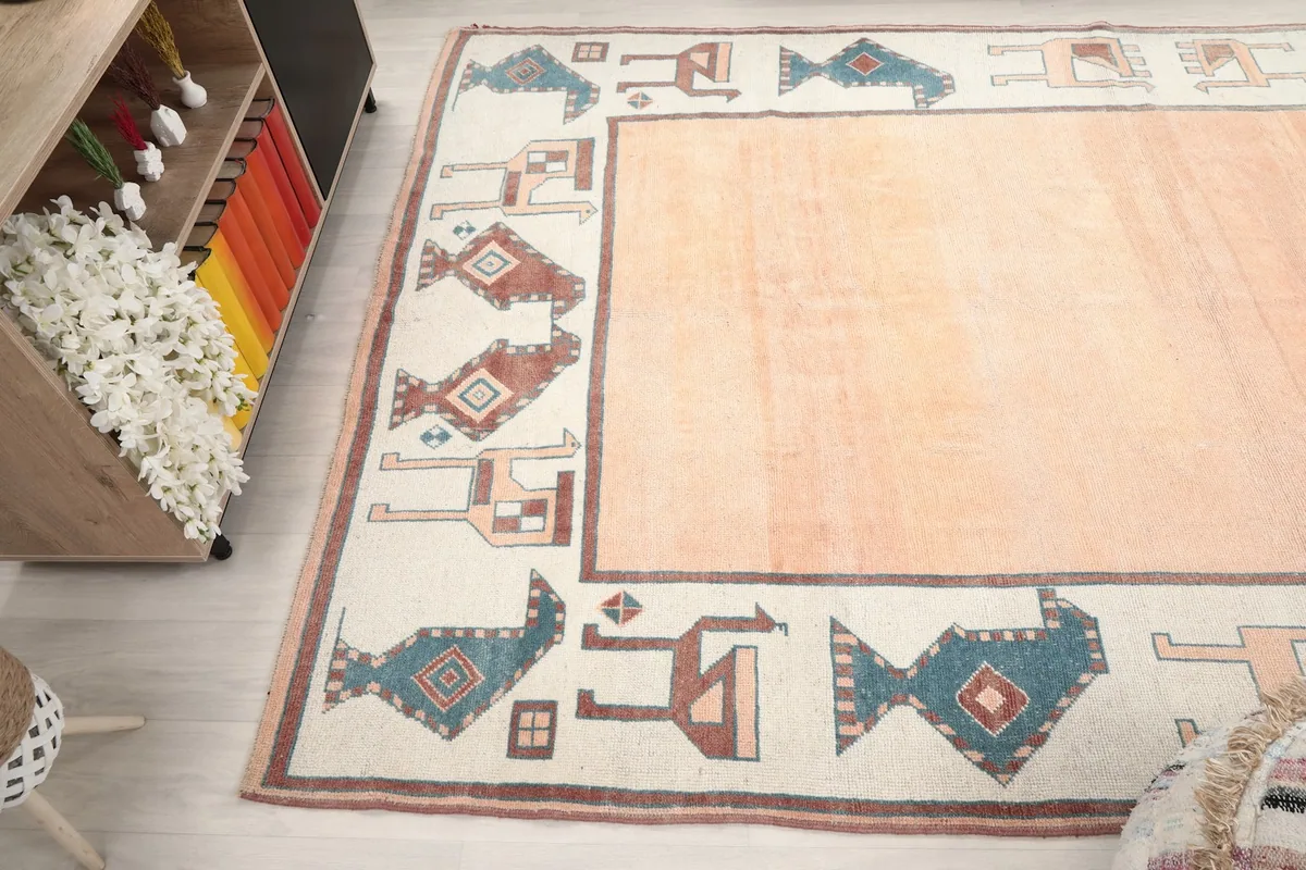 Angled perspective of the rug, emphasizing the full length of the border design