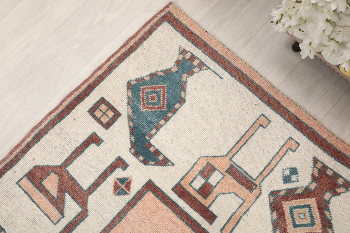 Detailed view of the corner border design with blue, rust, and ivory colors
