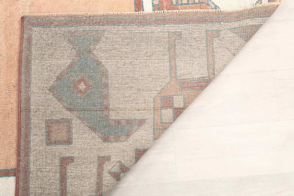 View of the underside of the hand-knotted rug, revealing the cotton foundation
