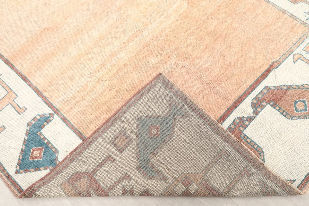 Folded corner of the rug showing the back and the hand-knotted construction