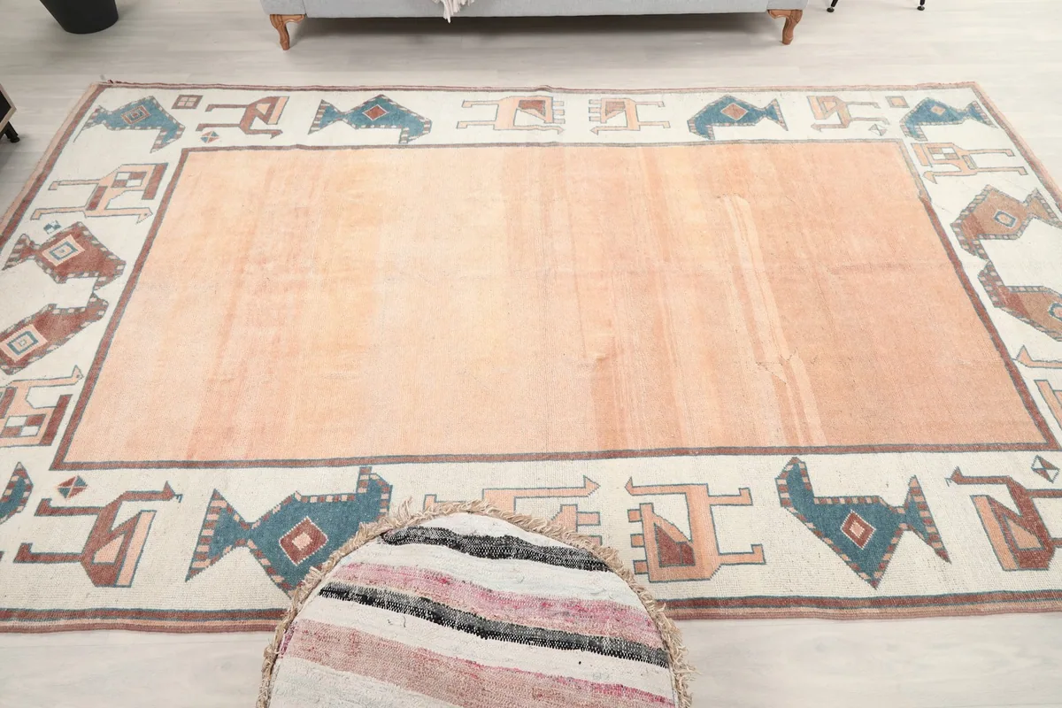 Full overhead view of the vintage orange and ivory rug from a slightly different angle