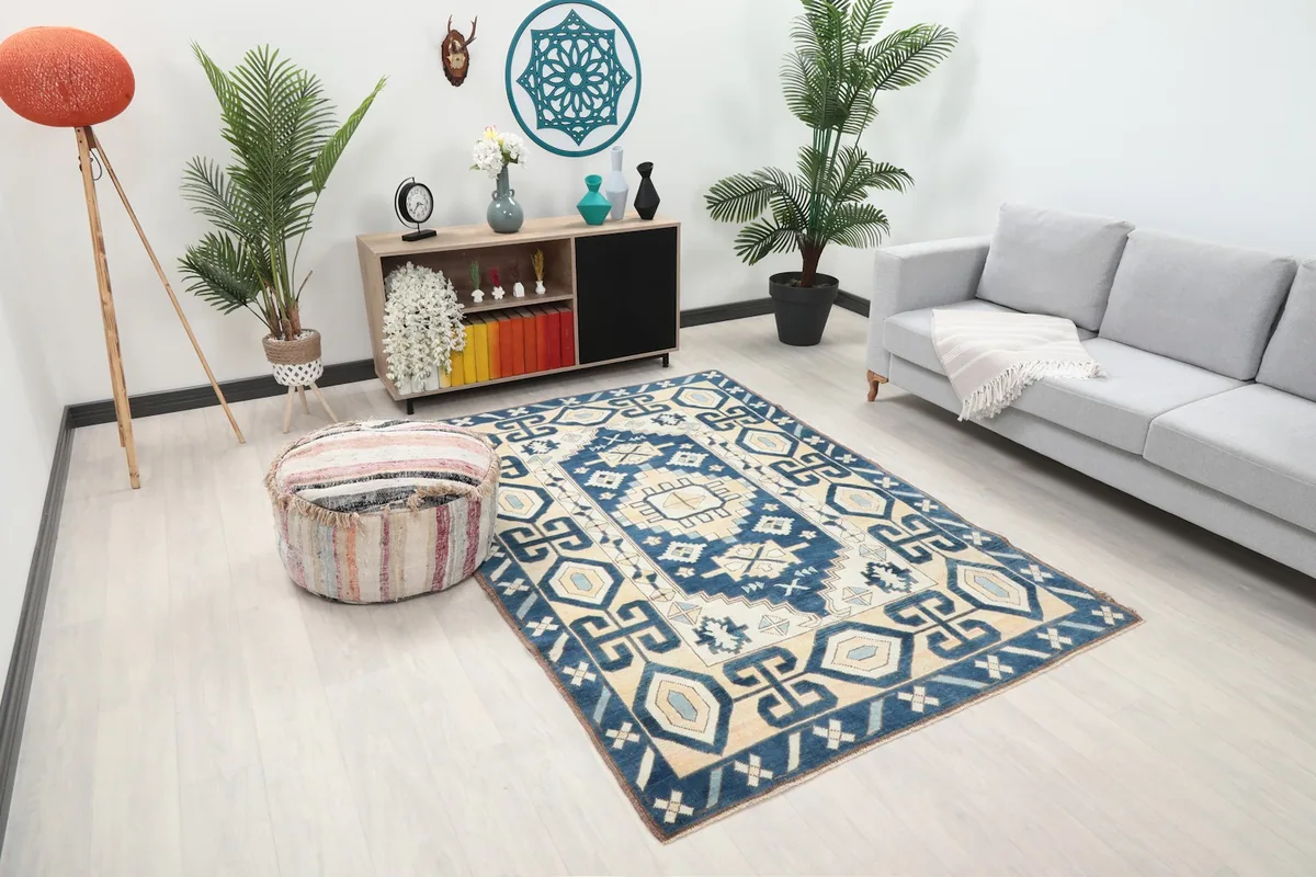 Overhead view of the navy and beige tribal rug in a living room, showing its placement.