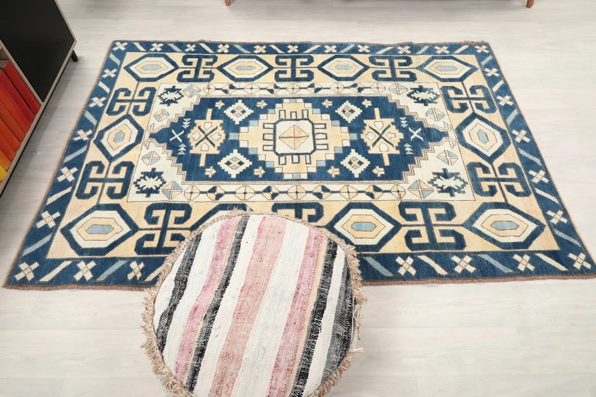 Overhead view of the entire rug, showcasing its dimensions and full tribal design in a room.