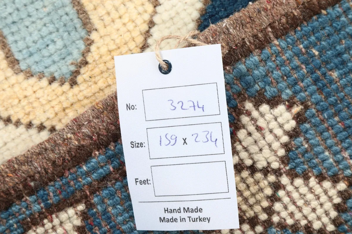 Close-up of the rug's tag, displaying the item number and size in centimeters.