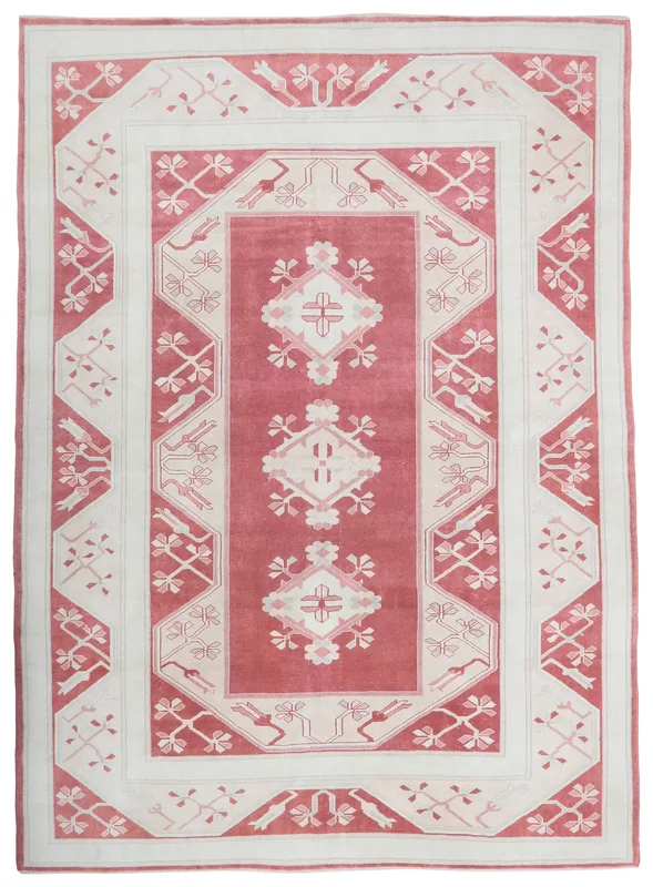 Full top view of the 7'7" x 10'6" rose and ivory vintage Anatolian rug