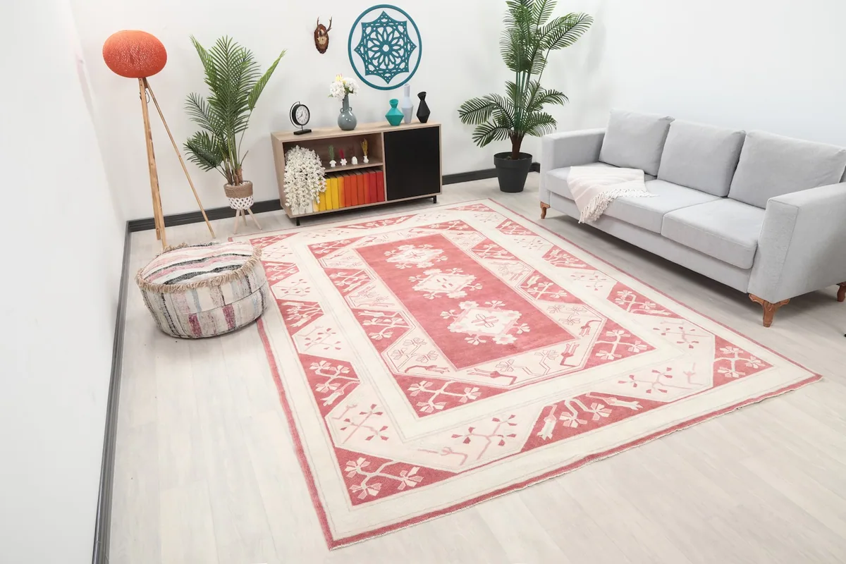 Wide angle view of the rose and ivory rug in a living space, showcasing its large size