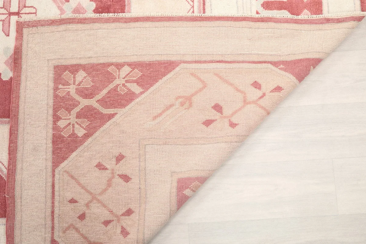 Underside view of the rug, showing the cotton foundation and hand-knotted details