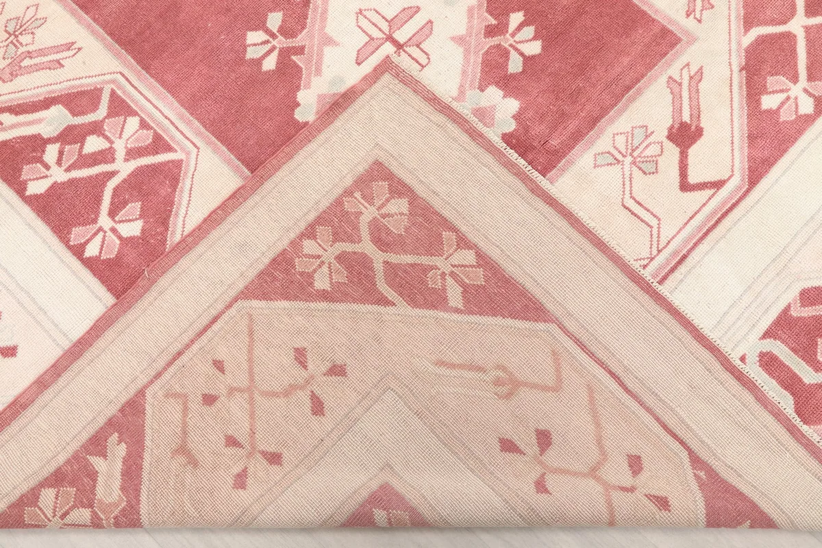 Folded corner of the rug, revealing the thickness and hand-knotted construction