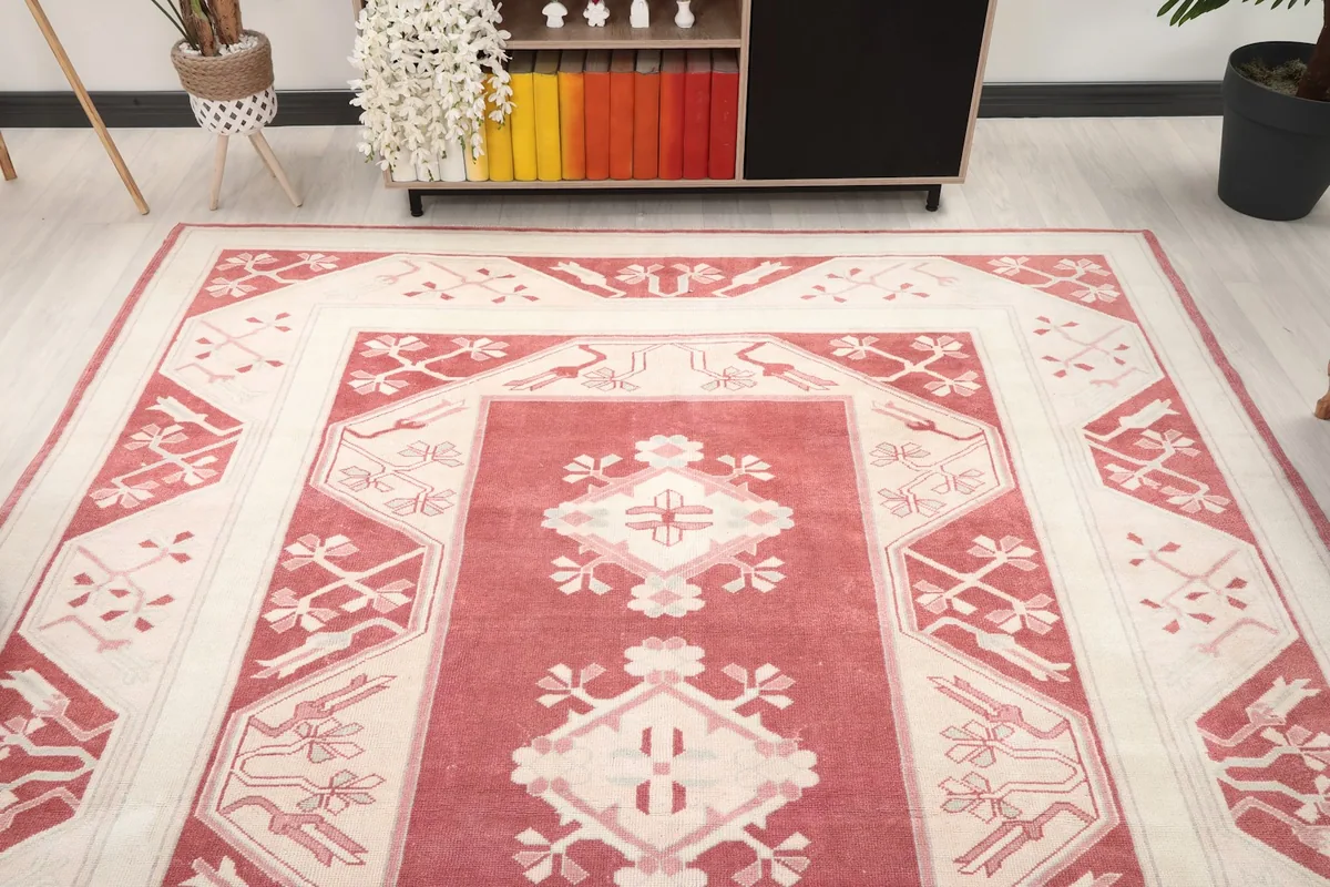 Overhead view showing the full pattern and design of the rose and ivory area rug