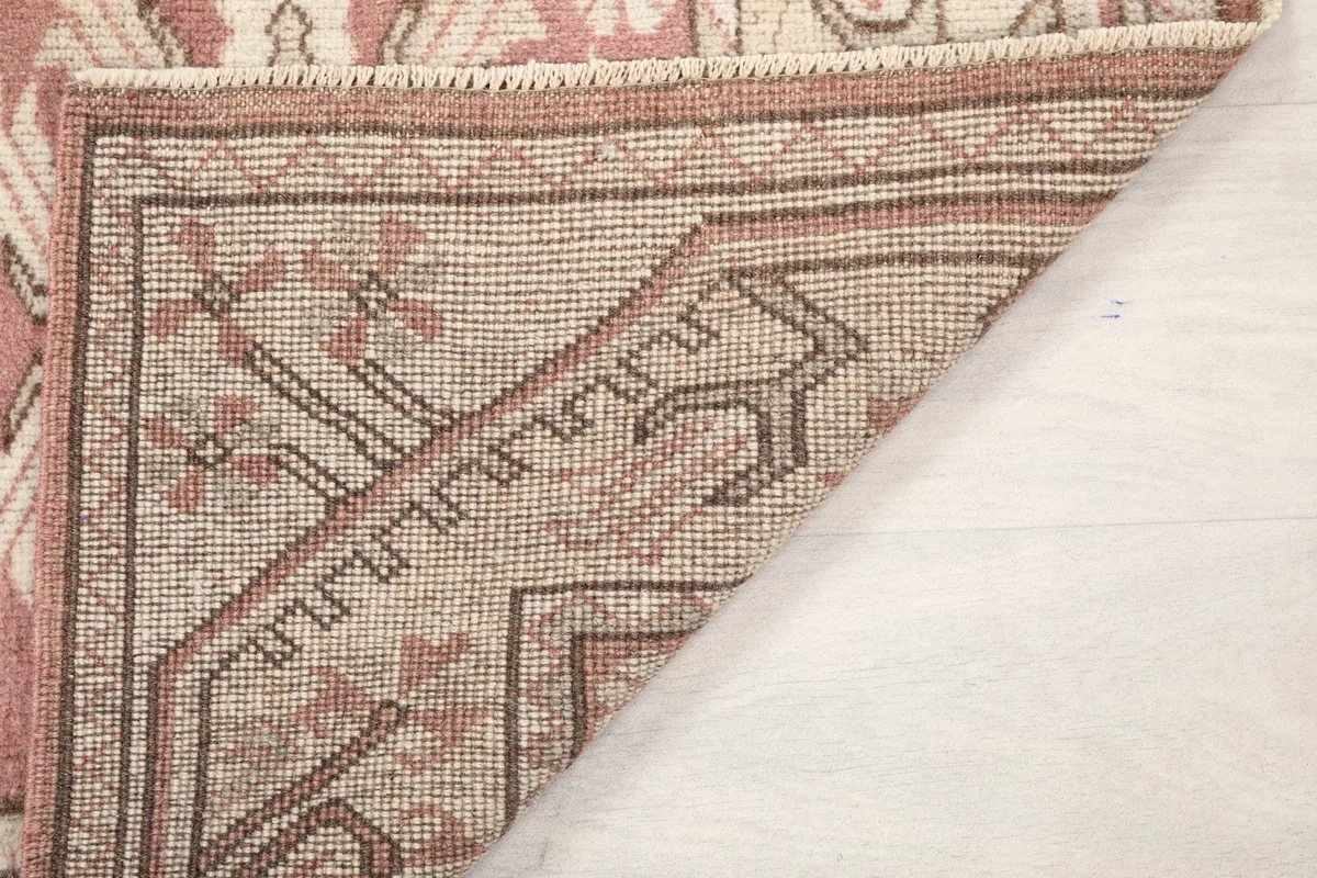 Close-up of the back of the rug, showing the hand-knotted cotton foundation