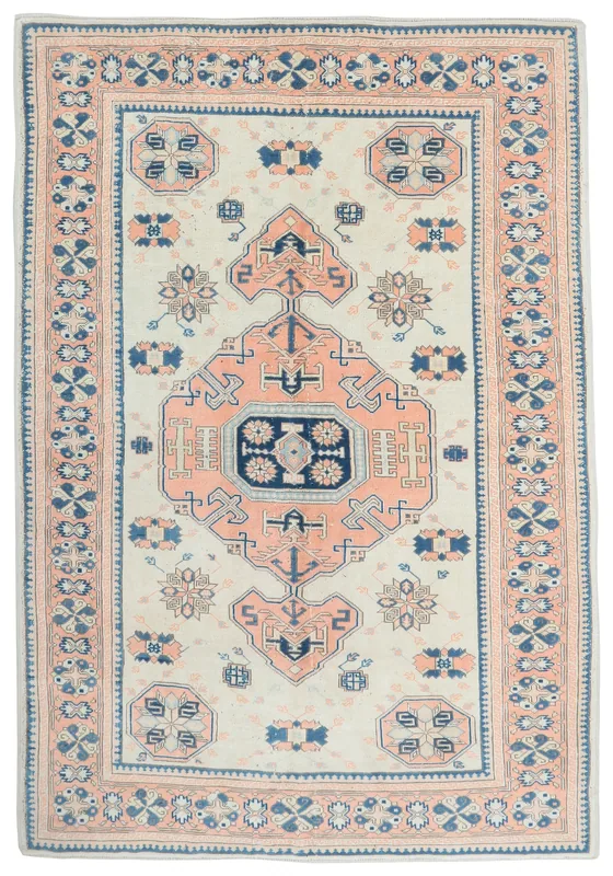 Full overhead view of the 6'6" x 9'2" ivory, rose, and navy vintage Anatolian area rug