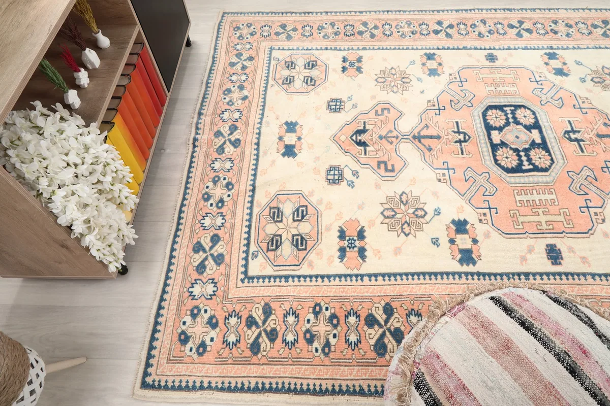 View of the rug from another angle, capturing the full width of the design and colors