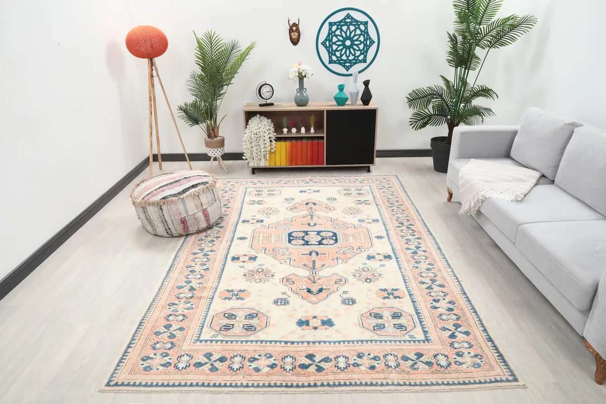 Ivory, rose, and navy vintage Anatolian rug showcased in a modern living room setting
