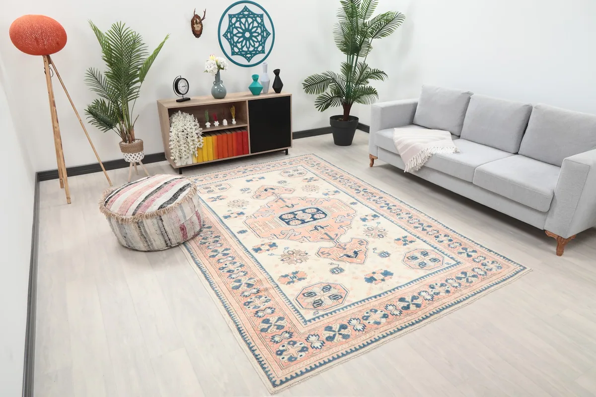 Angled view of the vintage Anatolian rug in a living space with light-colored furniture