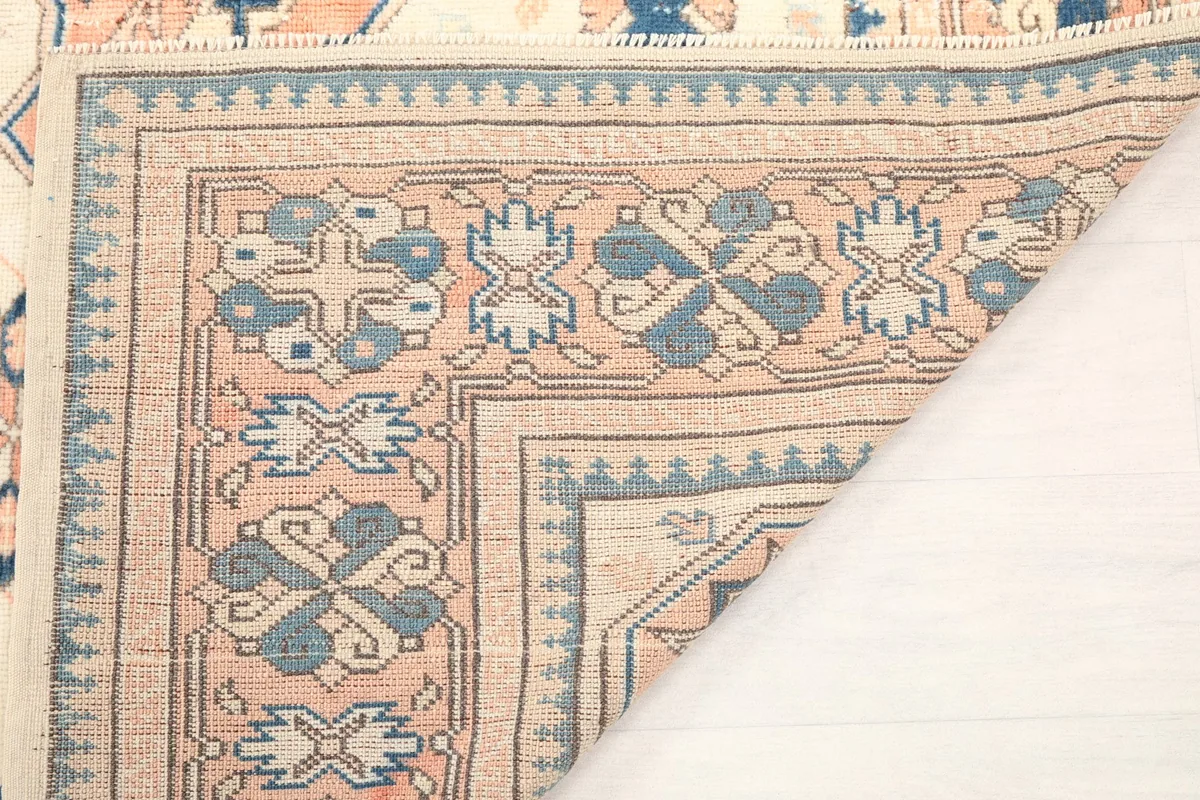 Another view of the folded rug corner, emphasizing the construction and pile texture