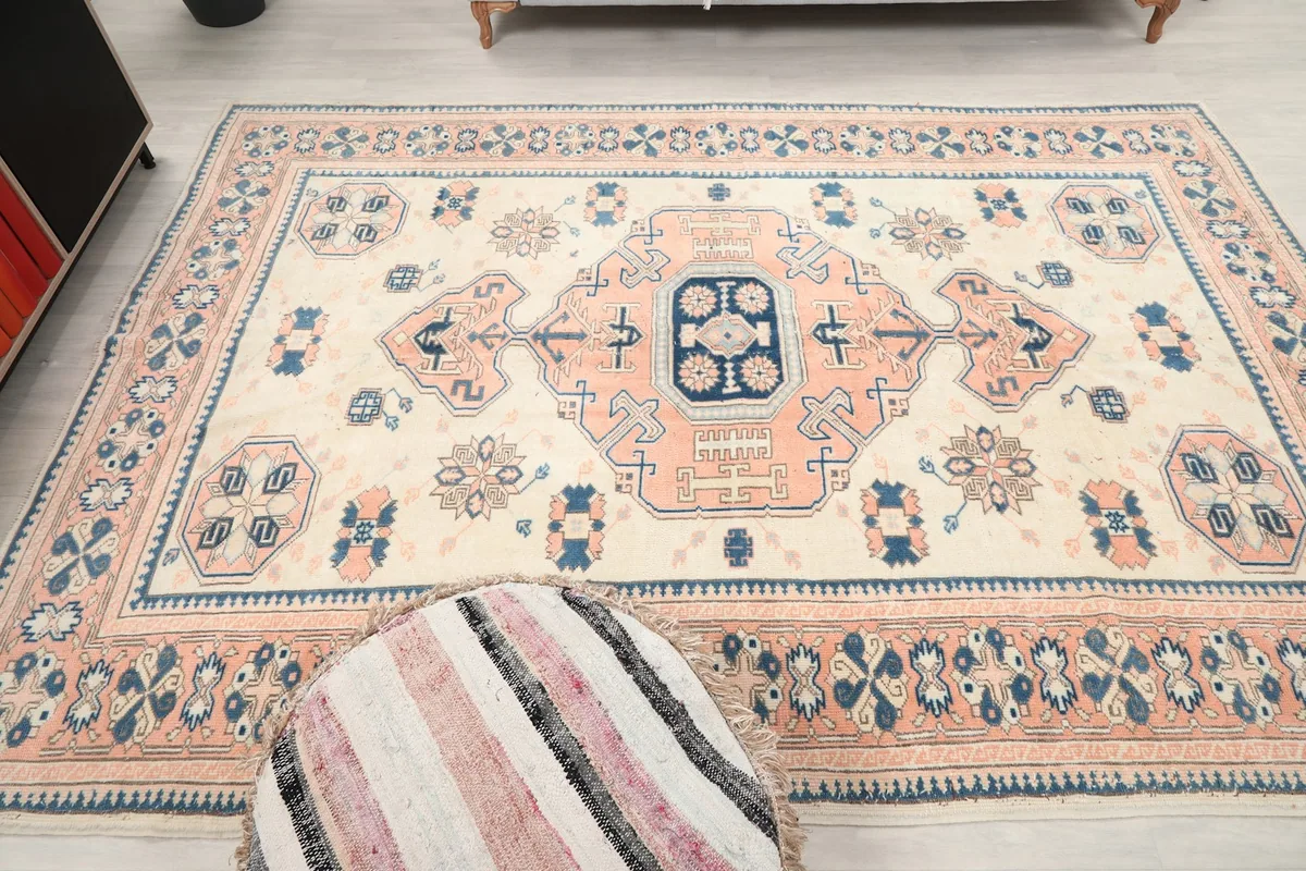 Overhead view of the rug with a decorative pouf, showing the full pattern layout