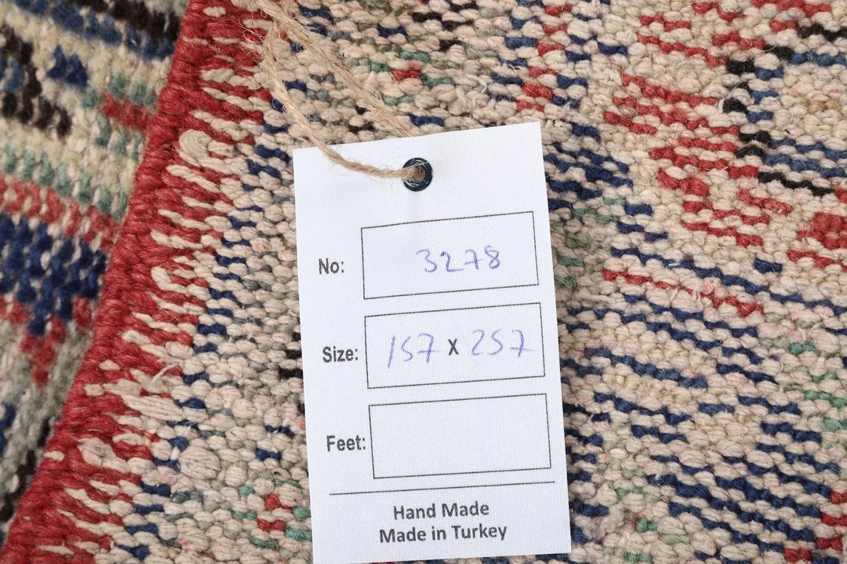 Tag showing the rug's dimensions and 'Hand Made Made in Turkey' on the back