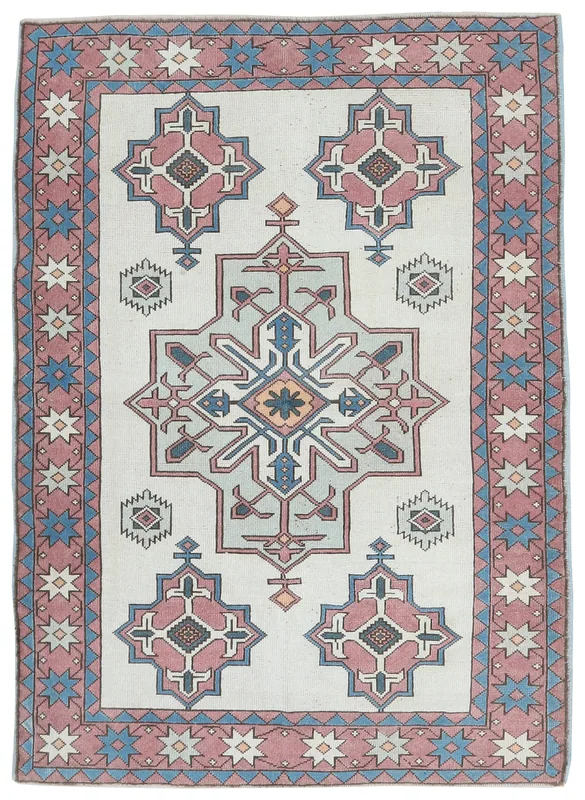 Top view of the 5x7 vintage Anatolian rug with cream field and rose border