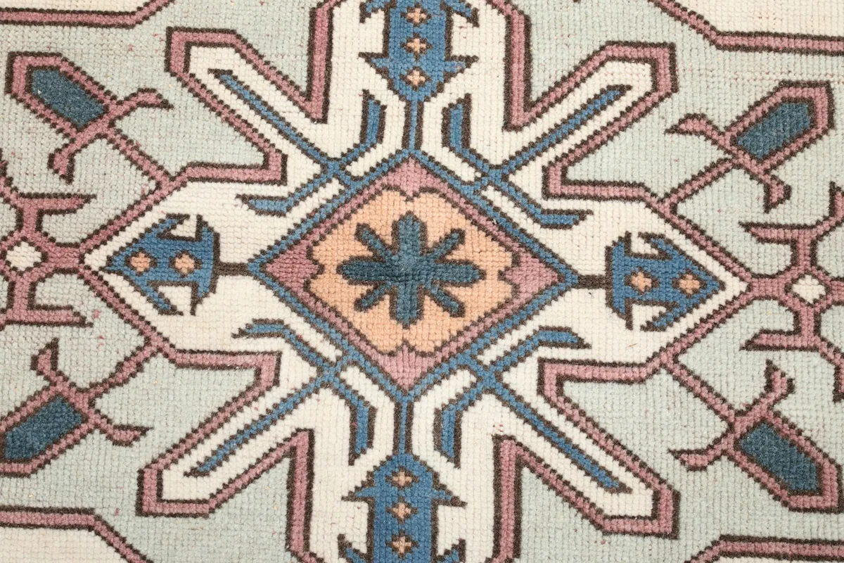 Detailed view of the central medallion's intricate blue, rose, and orange elements