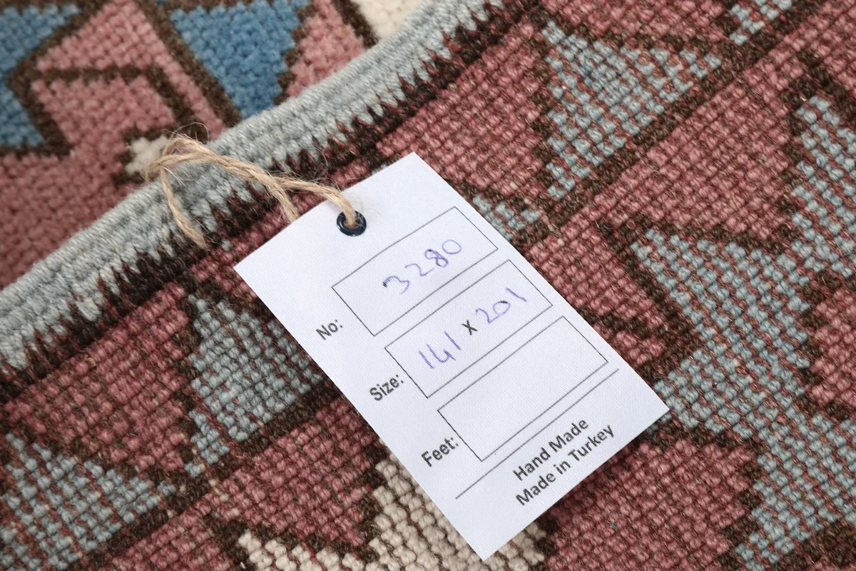 Close-up of the rug's reverse side with a tag indicating hand-made in Turkey