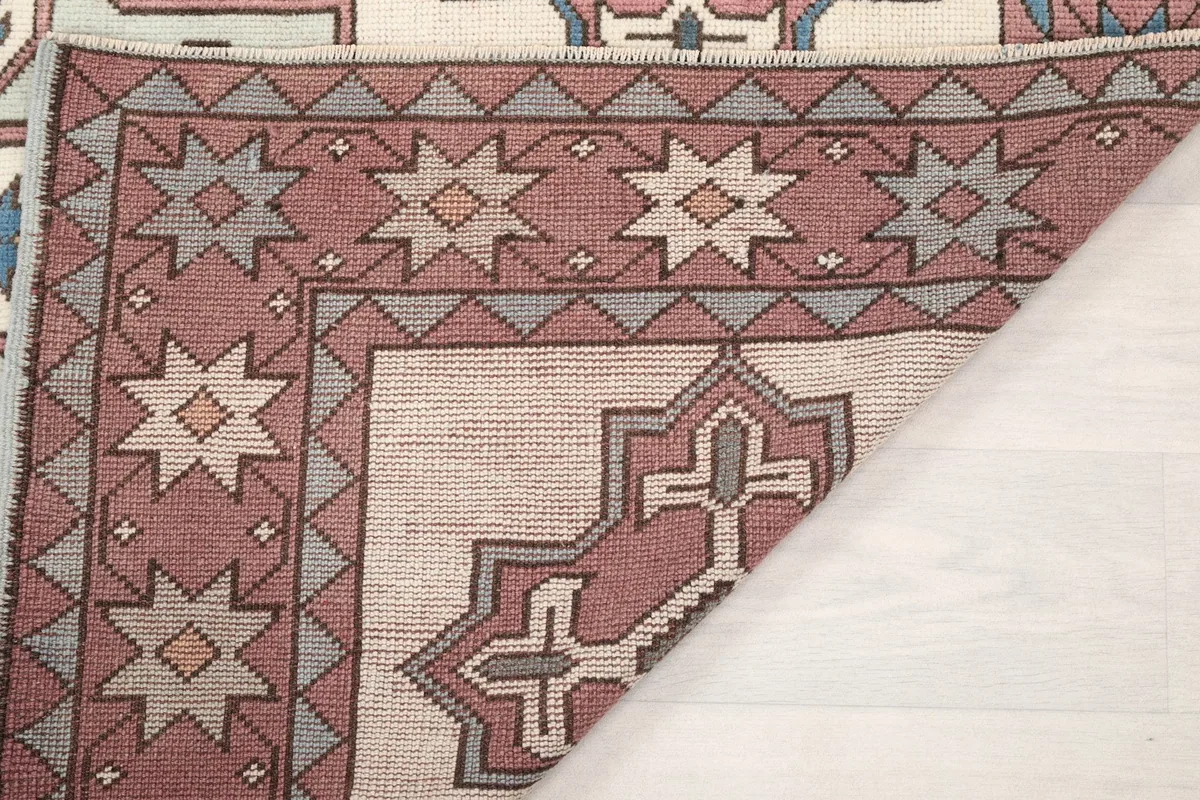 Another view of a folded corner, showing the rug's construction and reverse side