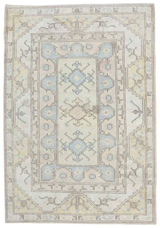 Full top view of the 6'6" x 9'9" cream and blue geometric vintage Anatolian area rug on a white background.