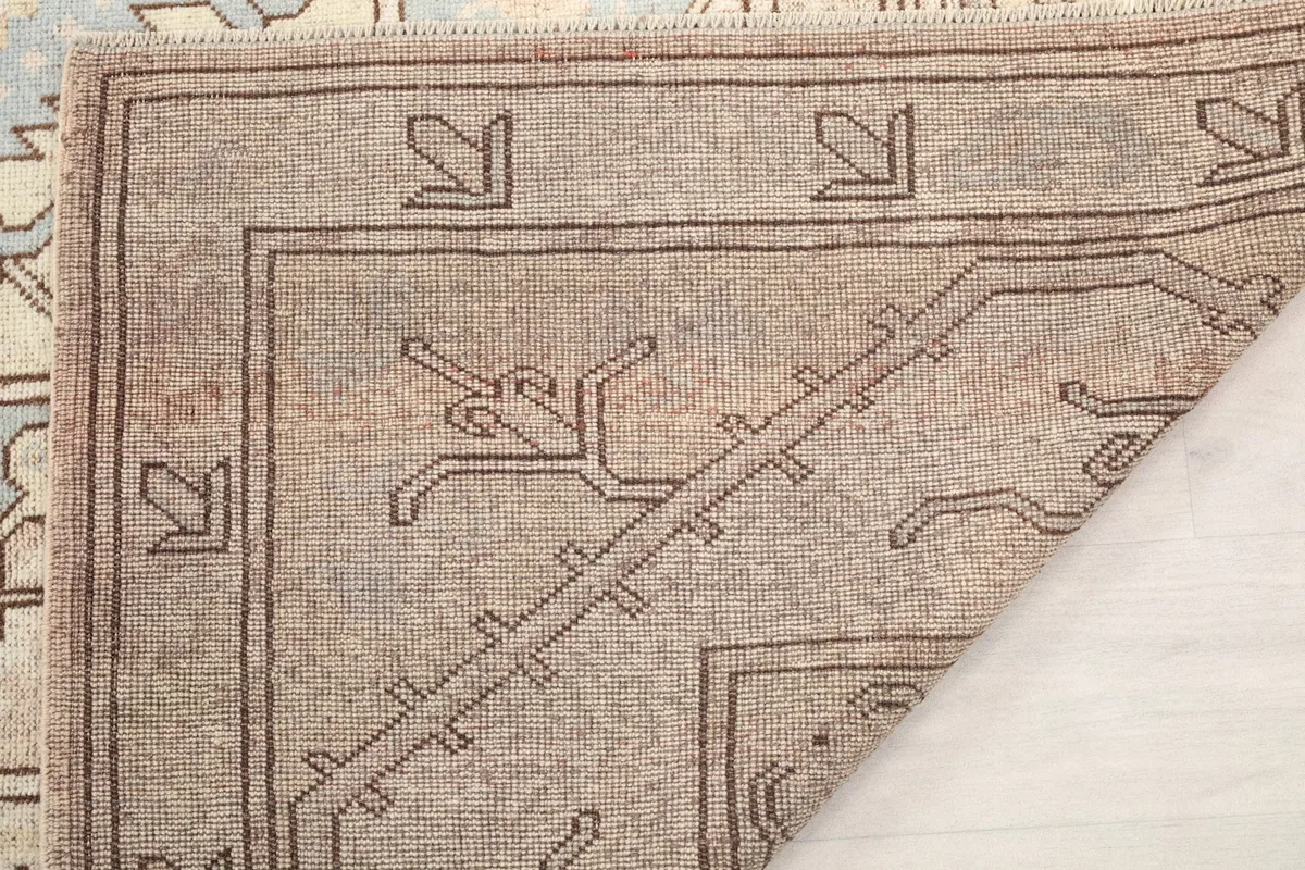 Another folded view of the rug's corner, highlighting the sturdy cotton foundation and craftsmanship.