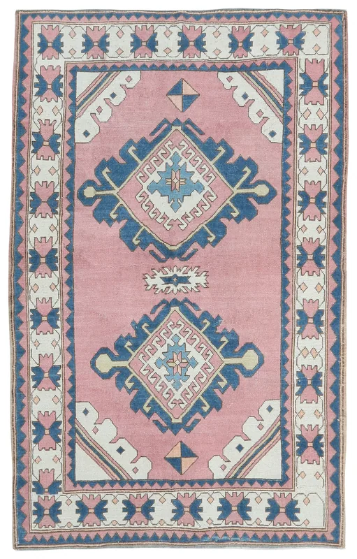 Full top view of the 5'3" x 7'2" rose and navy geometric Anatolian rug on a white background.