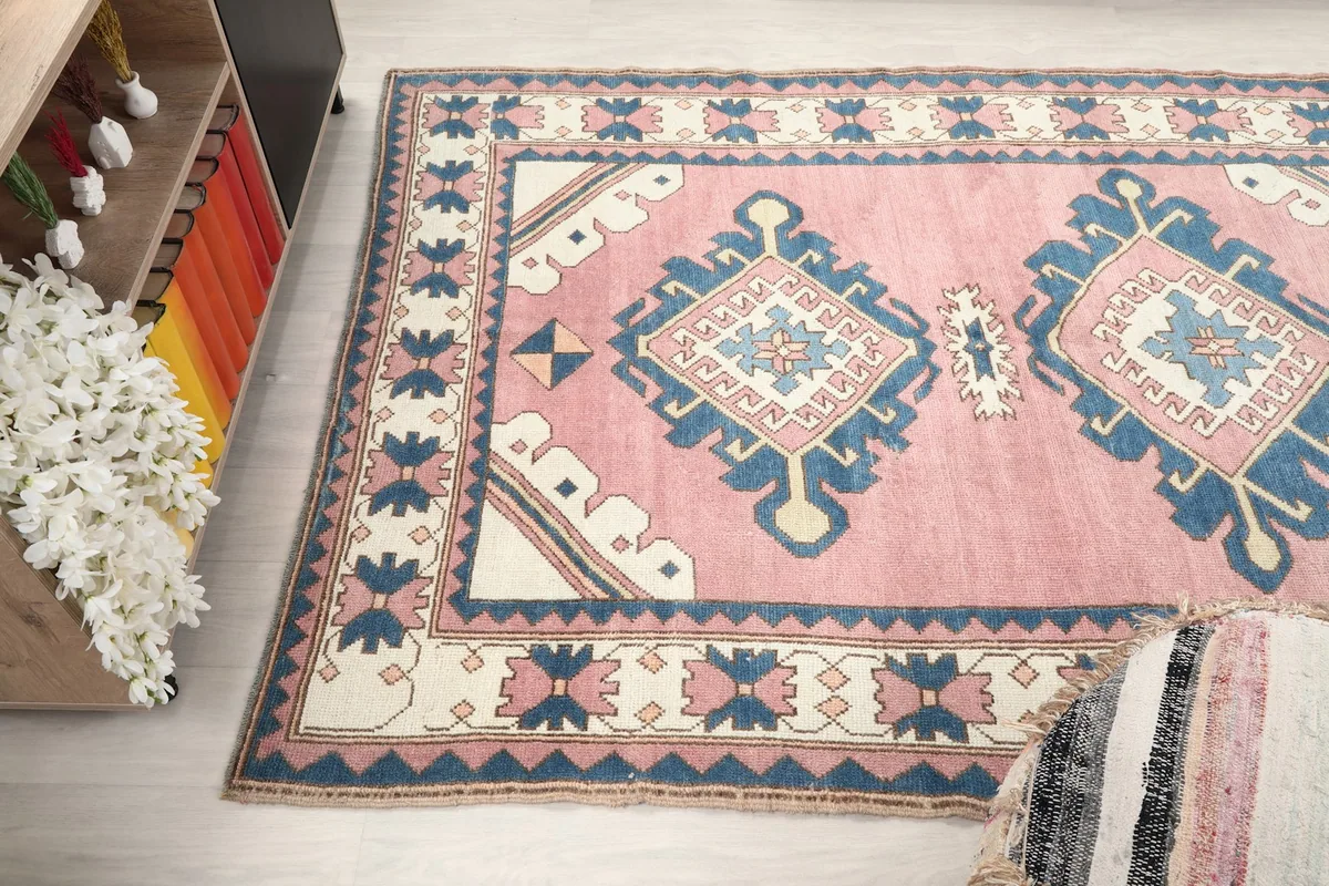 Wide angle view of the rug from above, showing its full length and the surrounding room decor.