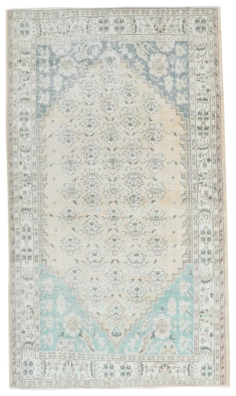 Full top view of the 5'3" x 8'0" beige and blue vintage Anatolian rug on a white background
