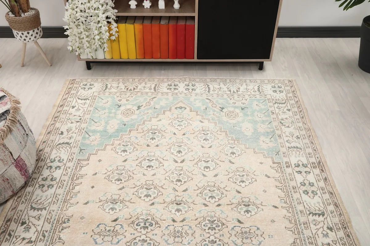 View of the rug in a room, focusing on the central design and surrounding decor