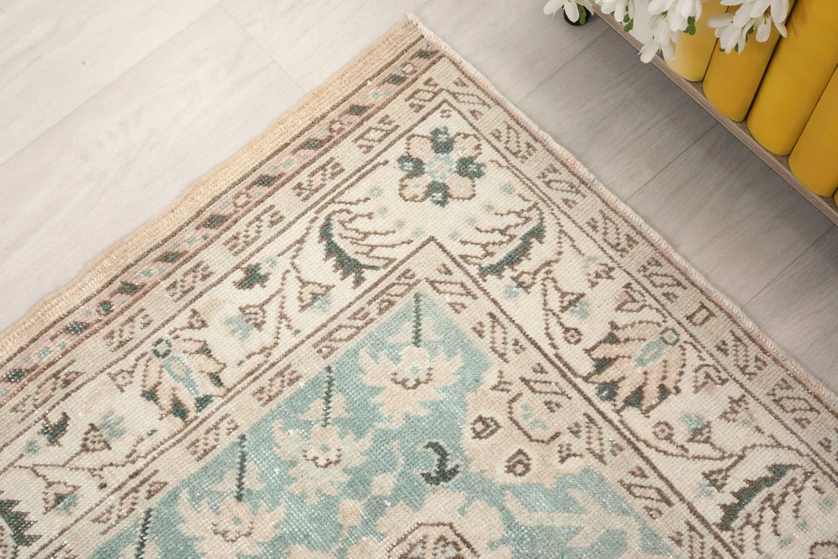 Close-up of the rug's border design and the intricate patterns at one corner