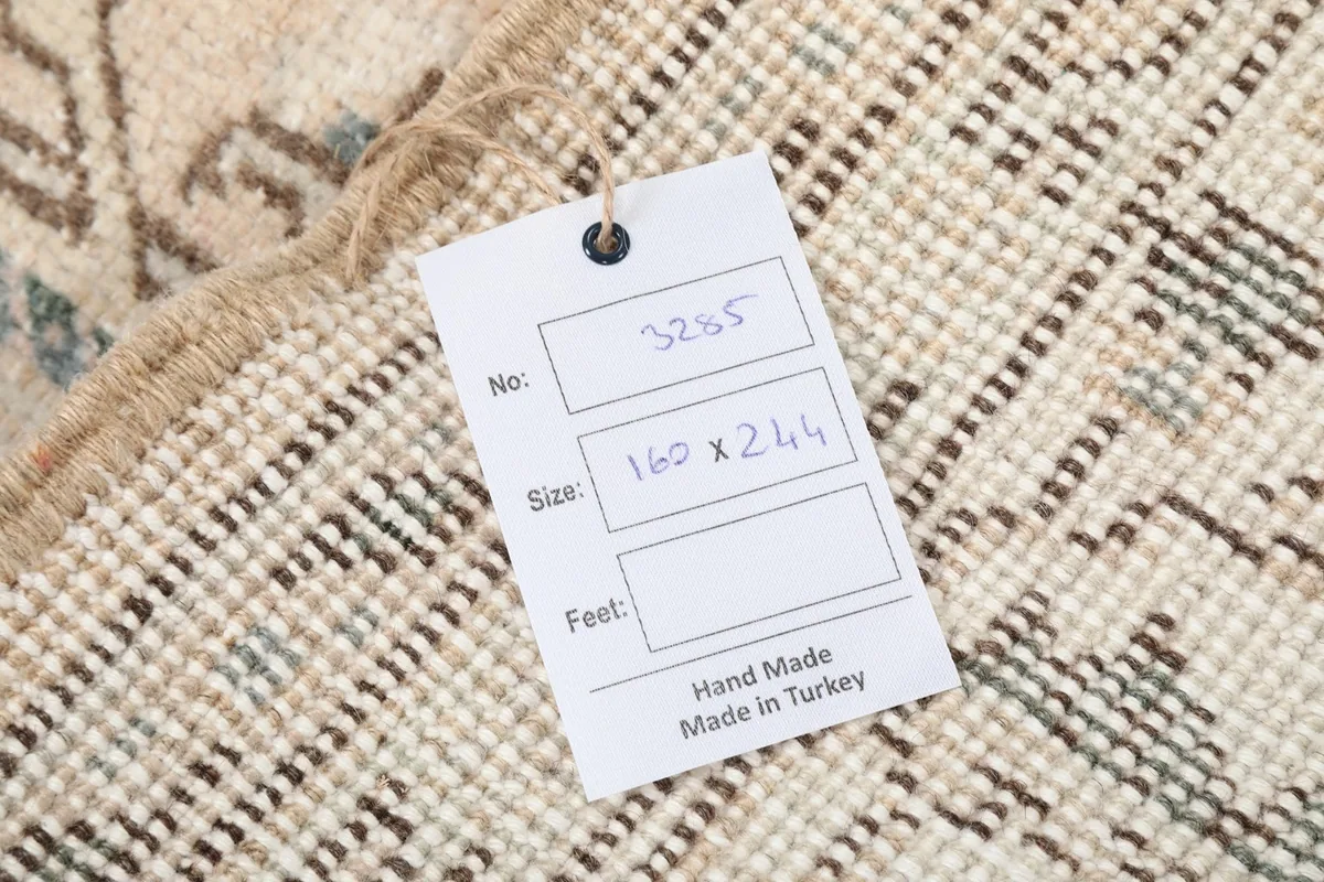 Close-up of the product tag attached to the rug, showing details like size and origin