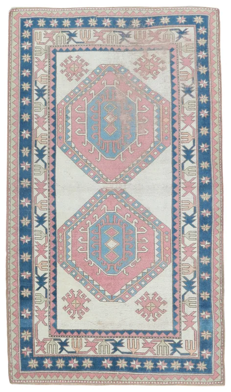 Full overhead view of the 5x8 ivory, pink, and blue vintage Anatolian area rug