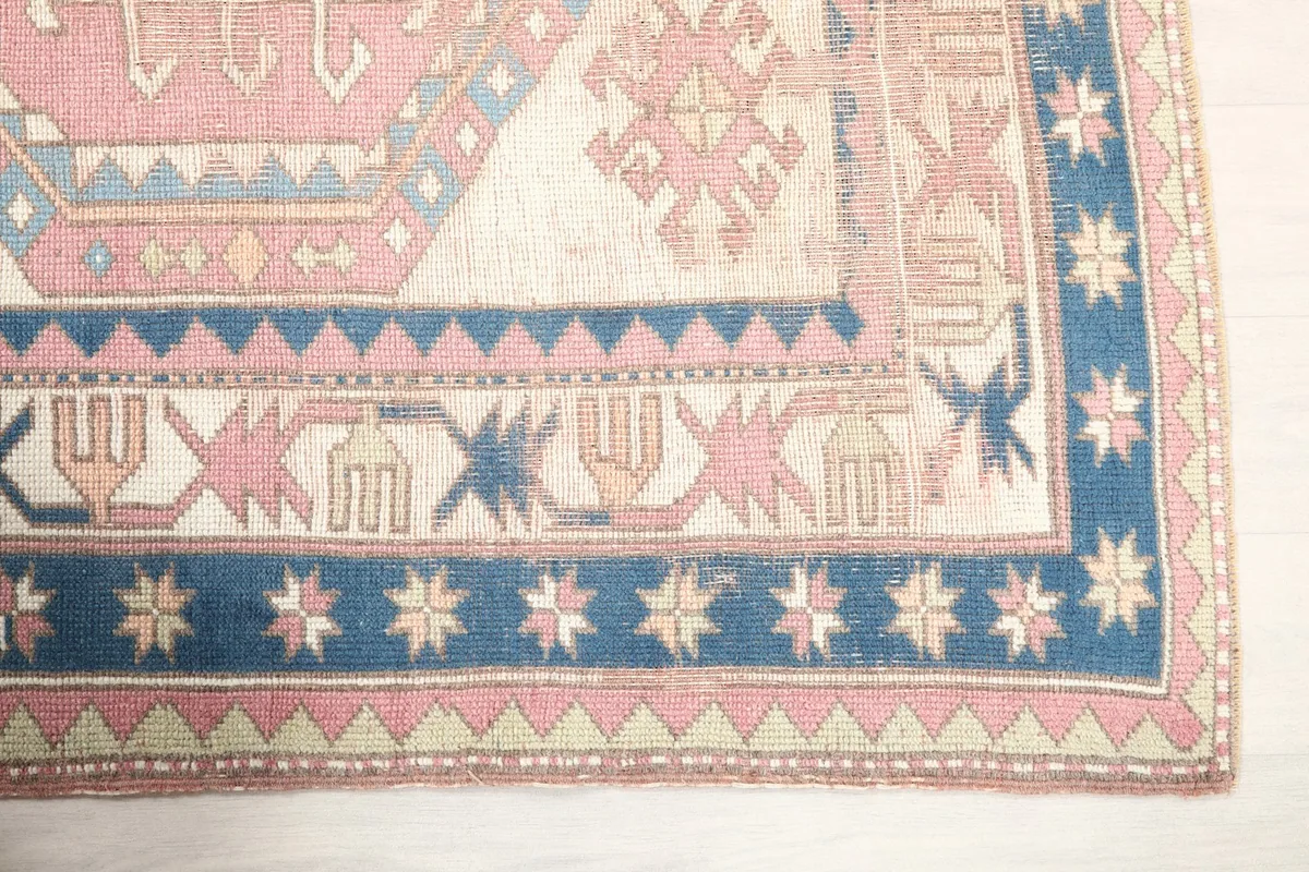 Detail of the rug's navy border with star motifs and the corner design