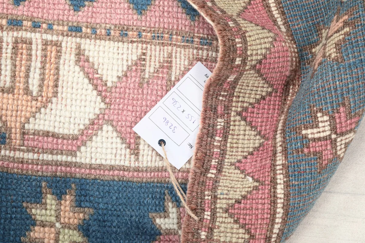 Folded corner of the rug with an attached tag showing product information