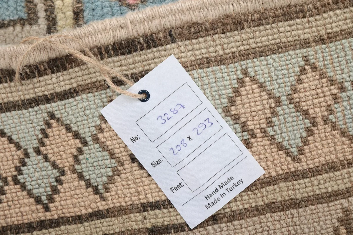 Close-up of the rug's tag, indicating its size and origin as hand-made in Turkey