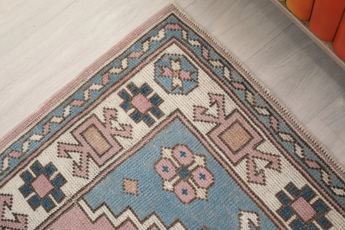 Close-up of the rug's corner, showing the intricate border design and colors