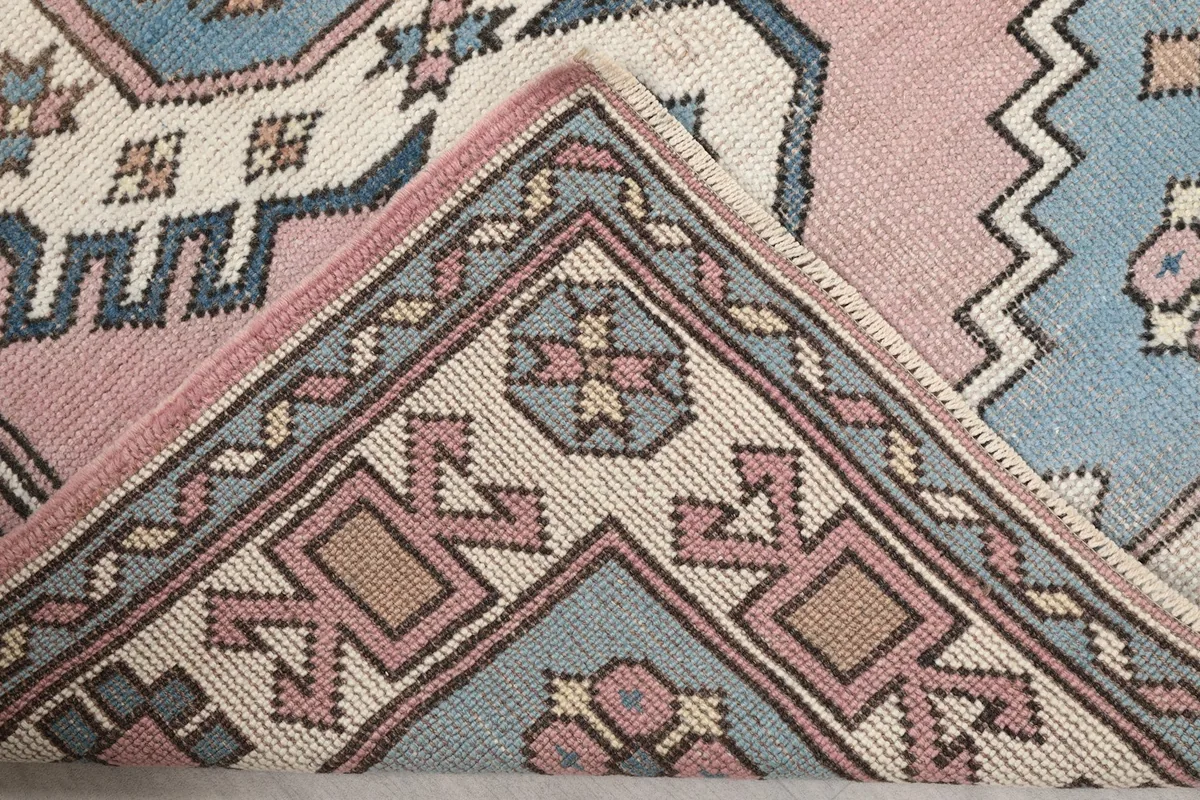 Folded corner of the rug showing the reverse side and knotting detail