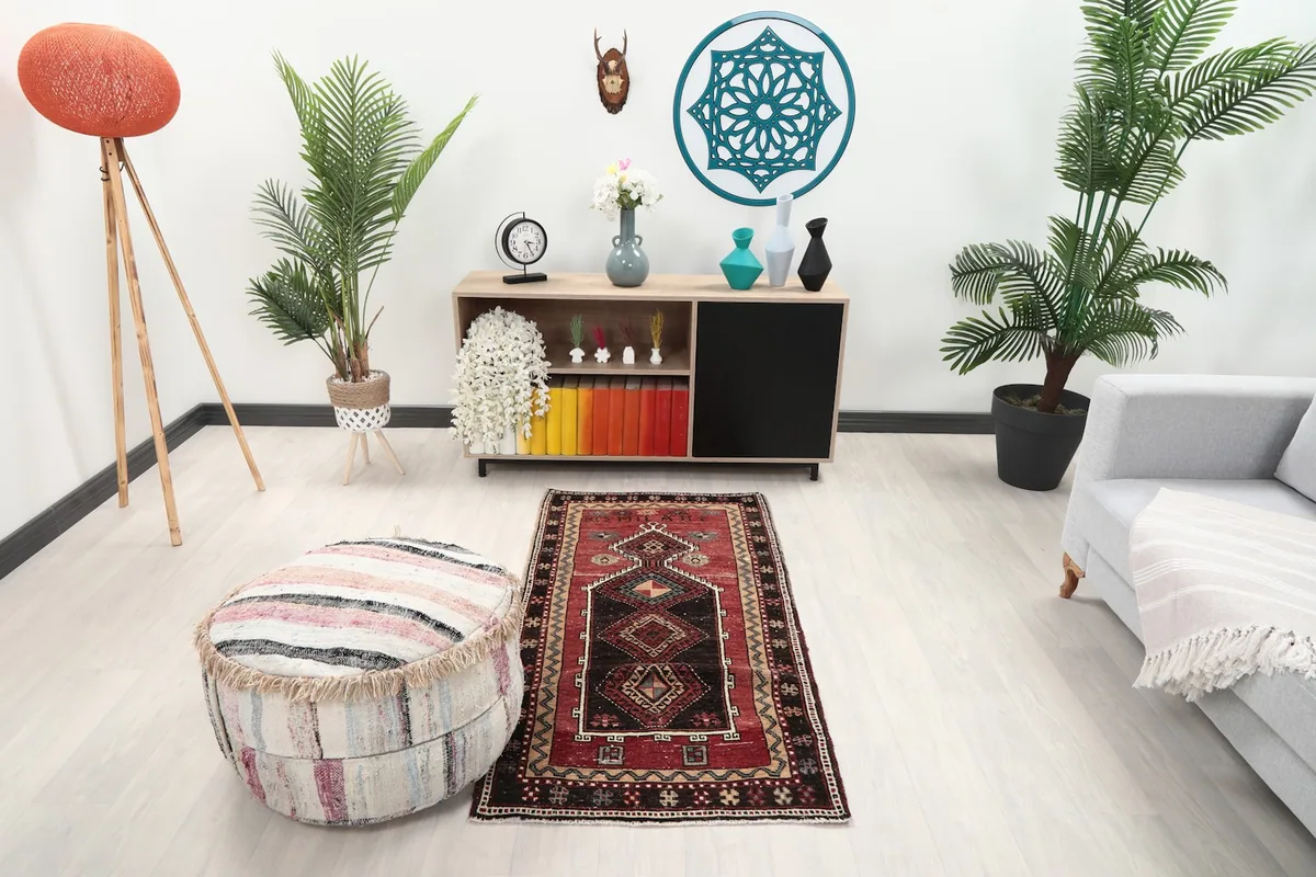 Vintage red tribal geometric rug placed in a modern living room setting