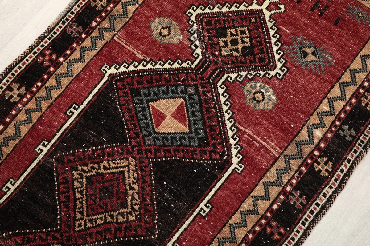 Close-up of the central geometric medallion and surrounding patterns in red and black