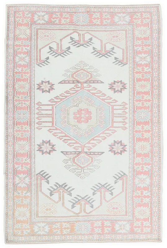 Full top view of the 4'3" x 6'3" vintage Anatolian rug with cream field and pink border