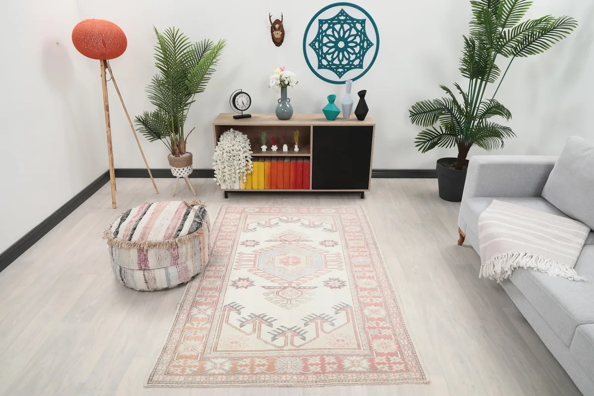 Vintage Anatolian rug in a living room setting, showcasing its size and colors with furniture