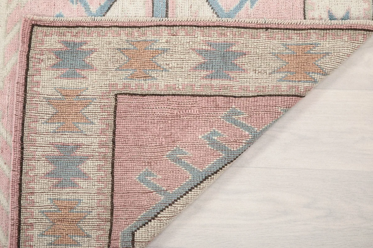 Underside view of the hand-knotted rug, showing the reverse of the patterns and weave.
