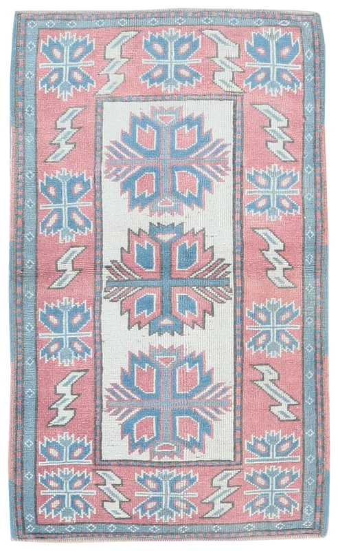 Full top view of a 2'6" x 4'2" vintage Anatolian rug with rose, ivory, and blue geometric patterns.
