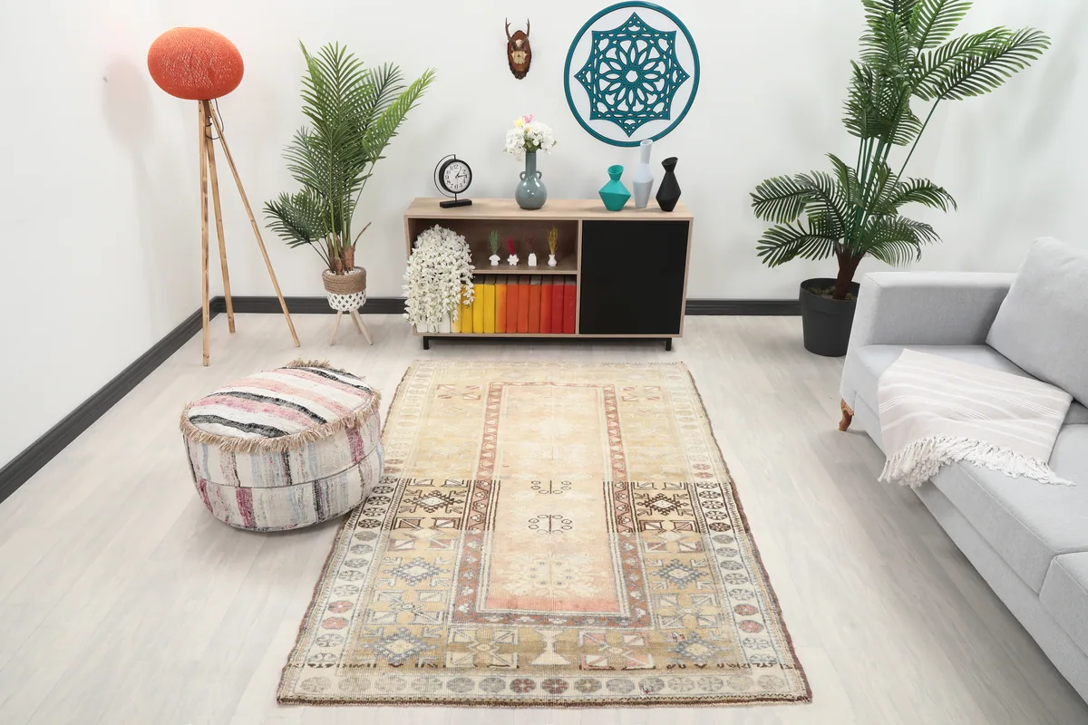 Faded Rose Tribal Anatolian Rug styled in a modern living space with a light sofa and plants.