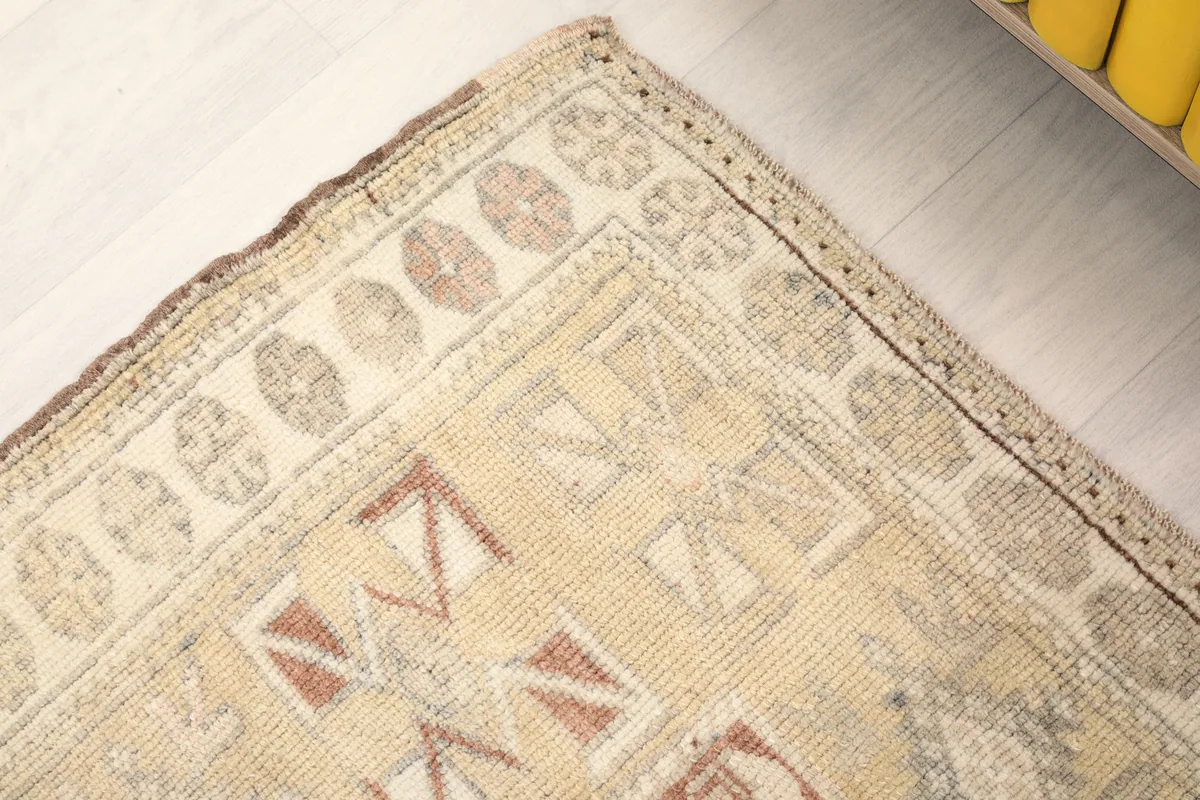 Corner detail of the Faded Rose Tribal Anatolian Rug, showcasing the outer border and corner motifs.