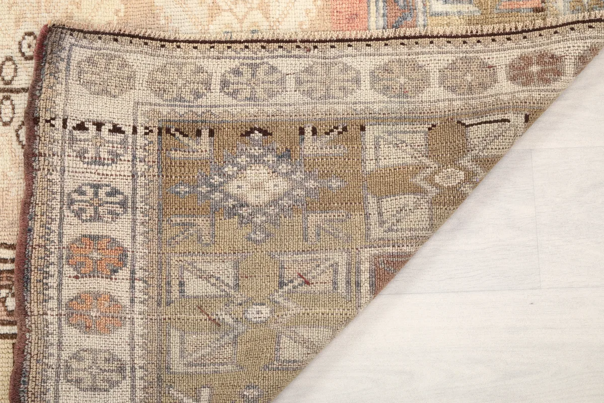 Folded corner of the Faded Rose Tribal Anatolian Rug to reveal the underside and construction details.